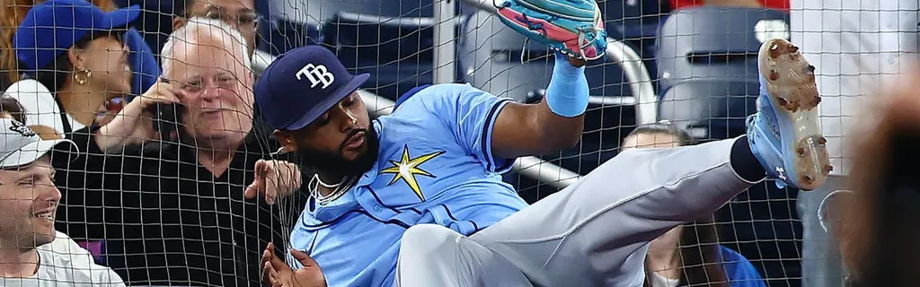 Junior Caminero makes a catch falling into netting